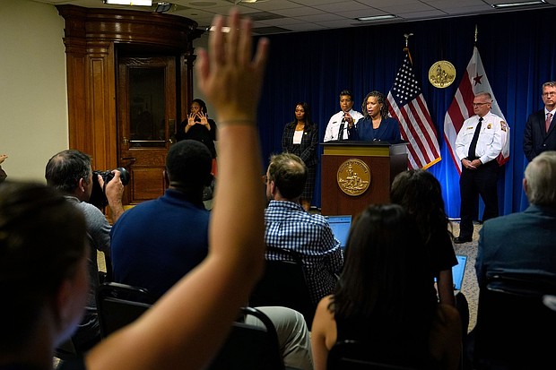 District of Columbia Mayor Muriel Bowser speaks as Metropolitan Police Department Chief Pamela Smith, on stage third left, and DC Fire and EMS Chief John Donnelly, on stage second right, listen during a news conference  on August 11 in Washington, DC.
Mandatory Credit:	Julia Demaree Nikhinson/AP via CNN Newsource