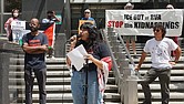 Virginia Defenders member Fernanda Diaz-Castro, center, addresses the crowd during a Monday afternoon rally at City Hall, where attendees called for a ban on cooperation with ICE.
