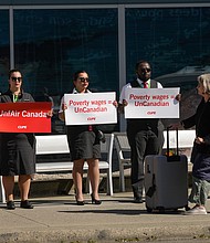 Air Canada flight attendants standing in a silent protest at Vancouver International Airport.
Mandatory Credit:	Liang Sen/Xinhua/Getty Images via CNN Newsource