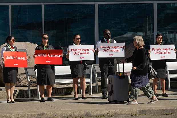 Air Canada flight attendants standing in a silent protest at Vancouver International Airport.
Mandatory Credit:	Liang Sen/Xinhua/Getty Images via CNN Newsource