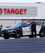 Police block the entrance to a Target after a shooting in Austin, Texas, on August 11.
Mandatory Credit:	Stephen Spillman/AP via CNN Newsource