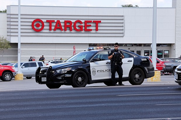 Police block the entrance to a Target after a shooting in Austin, Texas, on August 11.
Mandatory Credit:	Stephen Spillman/AP via CNN Newsource