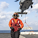 Aviation Ordnanceman 3rd Class Jader Jamecia, a native of Houston, takes position as an MH-60S Sea Hawk helicopter, assigned to the "Dragonslayers" of Helicopter Sea Combat Squadron (HSC) 11, transports ordnance to the Lewis and Clark-class supply ship USNS Robert E. Peary (T-AKE 5) from the flight deck of the Nimitz-class aircraft carrier USS Harry S. Truman (CVN 75) during an ammunition offload. Truman is currently underway in the Atlantic Ocean. (Photo by Mass Communication Specialist 2nd Class Logan McGuire)