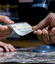 A customer purchases a Powerball lottery ticket in Austin, Texas. Monday night’s Powerball jackpot has climbed to $605 million, a new high for 2025, after going without a winner since the end of May.
Mandatory Credit:	Brandon Bell/Getty Images via CNN Newsource