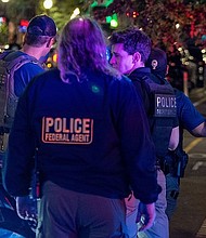 Washington DC Metro Police, along with FBI Agents, HSI, ATF and Secret Service Police respond to the nightlife area off U Street Corridor for a person with a gun on August 16, in Washington, DC.