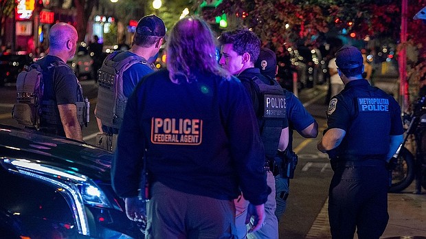 Washington DC Metro Police, along with FBI Agents, HSI, ATF and Secret Service Police respond to the nightlife area off U Street Corridor for a person with a gun on August 16, in Washington, DC.