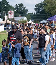 Students and their families gather at Speaking Spirit Ministries in Richmond on Saturday, Aug. 16, for Urban One Inc.’s Prep for Success Back to School Bash, receiving free supplies and community resources.