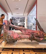 The Valentine removed the Jefferson Davis statue from its exhibition, “This Is Richmond, Virginia,” on Tuesday, Aug. 19, preparation for a loan to the Museum of Contemporary Art in Los Angeles for an upcoming exhibition. The statue, which had been on view since 2022, will remain part of The Valentine’s collection. Bonsai Fine Arts Handling assisted with the removal. “We’re so glad it is going to be shown to a new community and to see how Californians respond,” said Christina K. Vida, Elise H. Wright curator of general collections at The Valentine. During its three years on display, The Valentine collected more than 7,000 responses from a public survey on monuments and public art and plans to compile the feedback for a discussion event, comparing it with survey results from California while the statue is on display there. The statue will remain in its current condition, laid on its side with paint splatters, remnants of a 2020 toilet paper noose, a tear in its arm, and uric acid stains. “We really wanted to make sure that this piece was not ever going to be used to perpetuate the myth of the Lost Cause, and so by having it displayed in its 2020 state we can ensure that it helps undo some of the damage it did for so long here in Richmond,” Vida said.