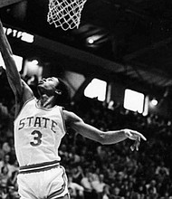 Clyde Austin soars near the rim during his playing days at North Carolina State University in the late 1970s.