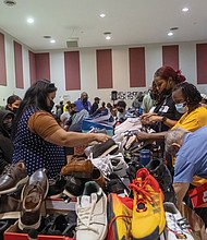 Volunteers and families gather inside Third Street Bethel A.M.E. Church for the 19th annual New Shoes for Back to School, organized by the Metropolitan Richmond Partnership of Churches/Synagogues with participants from congregations across the area giving Richmond area students new shoes to start the school year.