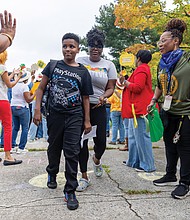 Aiden Fincher, a sixth grader at Henderson Middle School, is greeted Monday, Aug. 18, by cheering faculty, staff and Richmond Public Schools representatives on his first day of middle school. Students were also greeted with remarks from Superintendent Jason Kamras, school Principal Allen Vernon and others. RPS launched a staggered start to the 2025-26 school year to help students transition to middle and high school. Students in preschool, kindergarten, grades 1-5, sixth grade and ninth grade began Monday, while grades 7-8 and 10-12 started Tuesday, Aug. 19.