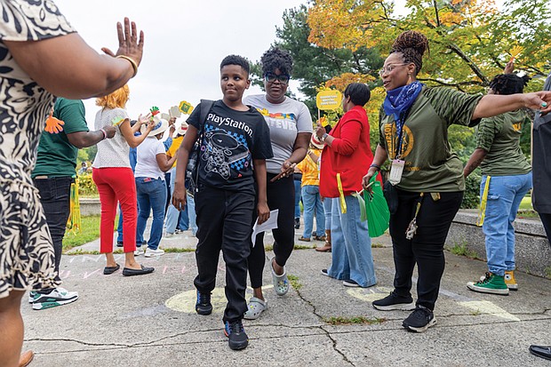 Aiden Fincher, a sixth grader at Henderson Middle School, is greeted Monday, Aug. 18, by cheering faculty, staff and Richmond Public Schools representatives on his first day of middle school. Students were also greeted with remarks from Superintendent Jason Kamras, school Principal Allen Vernon and others. RPS launched a staggered start to the 2025-26 school year to help students transition to middle and high school. Students in preschool, kindergarten, grades 1-5, sixth grade and ninth grade began Monday, while grades 7-8 and 10-12 started Tuesday, Aug. 19.