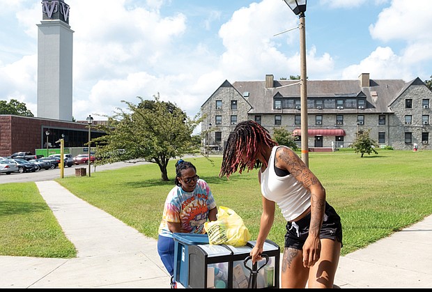 Wanda Williams helps daughter Deonna Glass move into Newman Hall on the campus of Virginia Union University, Saturday, Aug. 16.