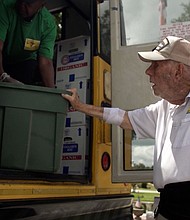 Bill Brown helps with a food delivery along the Children's Table weekly bus route.
Mandatory Credit:	CNN via CNN Newsource