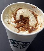 A Pumpkin Spice Latte drink rests on a table at a Starbucks in New York.
Mandatory Credit:	Richard Drew/AP via CNN Newsource