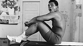 Muhammad Ali sits on a table in Miami in 1970.