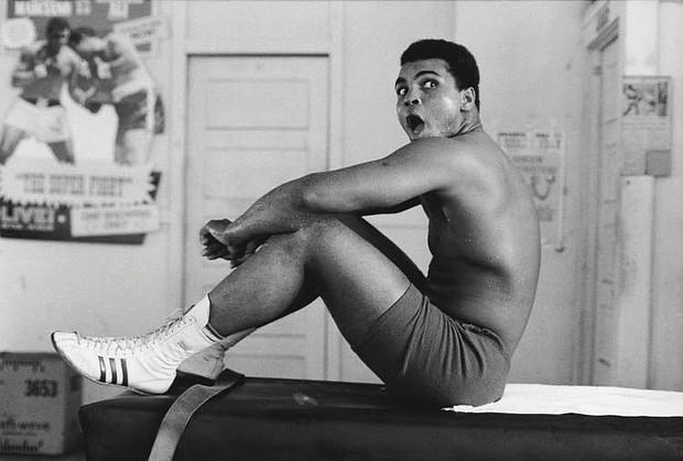 Muhammad Ali sits on a table in Miami in 1970.