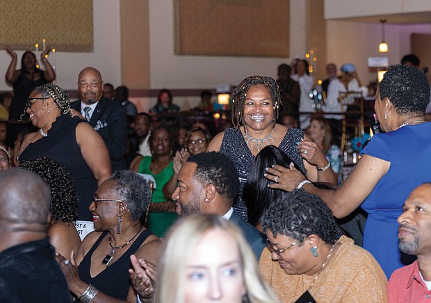 Kelly Jackson and Ammie Derricott, owners of Around The Table LLC, head to the stage to accept the Rising Community Impact Award at the BLK RVA Community Awards.