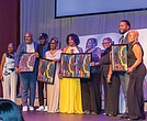 Award winners pose on stage at the Hippodrome. Pictured left to right: Evette Roots, vice president and senior social impact and sustainability specialist, Wells Fargo; Micheal Sparks, CEO of The Underground Kitchen; JP Mines and his mother, Pam Mines, founder of the JP JumPers Foundation; Shakia Gullette Warren, executive director of the Black History Museum & Cultural Center of Virginia; Ammie Derricott and Kelly Jackson, owners of Around The Table LLC; James Crump-Wallace, founder of Celebration of Black Music in Film; and host Clovia Lawrence, community outreach director for Radio One Inc.