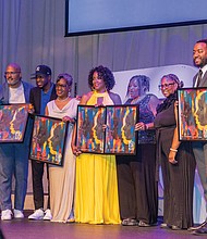 Award winners pose on stage at the Hippodrome. Pictured left to right: Evette Roots, vice president and senior social impact and sustainability specialist, Wells Fargo; Micheal Sparks, CEO of The Underground Kitchen; JP Mines and his mother, Pam Mines, founder of the JP JumPers Foundation; Shakia Gullette Warren, executive director of the Black History Museum & Cultural Center of Virginia; Ammie Derricott and Kelly Jackson, owners of Around The Table LLC; James Crump-Wallace, founder of Celebration of Black Music in Film; and host Clovia Lawrence, community outreach director for Radio One Inc.