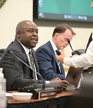 Gregory Washington, president of George Mason University, speaks with a guest during a Aug. 1 Board of Visitors meeting.