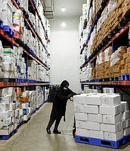 A worker pushes a cart of packaged frozen shrimp at a factory on the outskirts of Vishakhapatnam, India.
Mandatory Credit:	Sahiba Chawdhary/Reuters via CNN Newsource