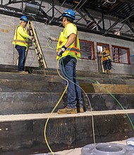 Construction workers install wiring in the soon to be auditorium of the new Richmond High School for the Arts, a $140 million project under construction off Midlothian Turnpike. The school will accommodate about 1,800 students and offer facilities for programs including dance, music and video production. Completion is expected in winter 2026.