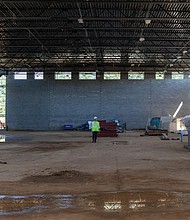 Richmond Public Schools Superintendent Jason Kamras stands in the center of what will be the gymnasium of the new Richmond High School for the Arts, a $140 million facility currently under construction. The school, designed to serve about 1,800 students, will offer specialized spaces for dance, music, video production and other creative programs, giving students modern tools to develop their talents.Officials say the project is on track for completion in winter 2026. (Julianne Tripp Hillian/Richmond Free Press)