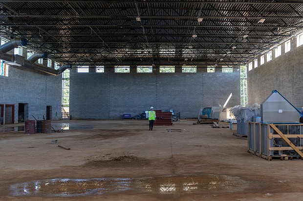 Richmond Public Schools Superintendent Jason Kamras stands in the center of what will be the gymnasium of the new Richmond High School for the Arts, a $140 million facility currently under construction. The school, designed to serve about 1,800 students, will offer specialized spaces for dance, music, video production and other creative programs, giving students modern tools to develop their talents.Officials say the project is on track for completion in winter 2026. (Julianne Tripp Hillian/Richmond Free Press)