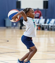 Daniel Crane, 6, takes aim at hoops during halftime of the Richmond Roadrunners women’s professional basketball game against the Maryland Lady Wolves on Saturday, Aug. 23, at the Henrico Sports & Events Center.