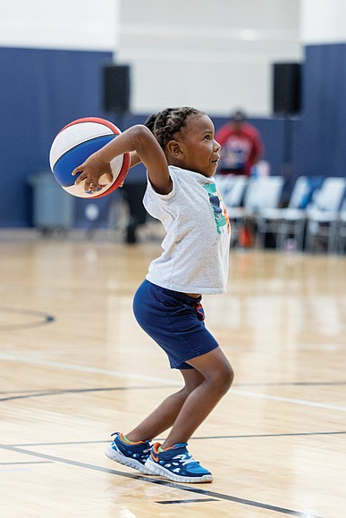 Daniel Crane, 6, takes aim at hoops during halftime of the Richmond Roadrunners women’s professional basketball game against the Maryland Lady Wolves on Saturday, Aug. 23, at the Henrico Sports & Events Center.
