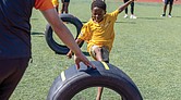 Ahmel, 5, kicks a ball through a race car tire at a soccer clinic Friday, Aug. 15, at the Boys & Girls Clubs of Metro Richmond on Bainbridge Street in South Side.