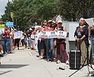 Protesters hold signs outside Richmond City Hall on Aug. 11 during a rally against recent Immigration and Customs Enforcement detentions, urging
the city to block local cooperation with federal immigration authorities.