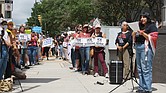 Protesters hold signs outside Richmond City Hall on Aug. 11 during a rally against recent Immigration and Customs Enforcement detentions, urging
the city to block local cooperation with federal immigration authorities.