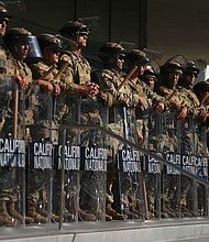 California National Guard members are positioned at the Federal Building in downtown Los Angeles on June 10.
Mandatory Credit:	Eric Thayer/AP via CNN Newsource
