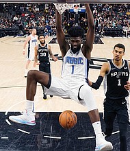 Orlando Magic forward Jonathan Isaac scores past San Antonio Spurs center Victor
Wembanyama during the first half Wednesday, Jan. 31, 2024. Isaac wears a version of
his shoe, the Unitus Judah 1.