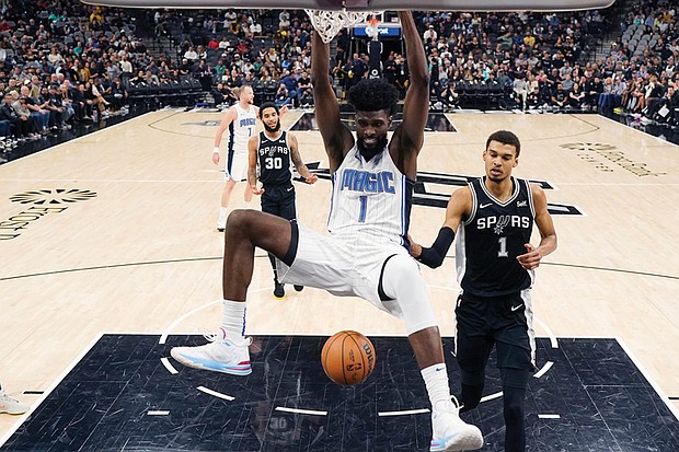 Orlando Magic forward Jonathan Isaac scores past San Antonio Spurs center Victor
Wembanyama during the first half Wednesday, Jan. 31, 2024. Isaac wears a version of
his shoe, the Unitus Judah 1.