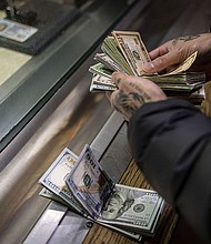 A man pays cash bail in the bond office to secure his brother's release in December 2022, at Division 5 of the Cook County Jail.
Mandatory Credit:	Brian Cassella/Chicago Tribune/Tribune News Service/Getty Images via CNN Newsource