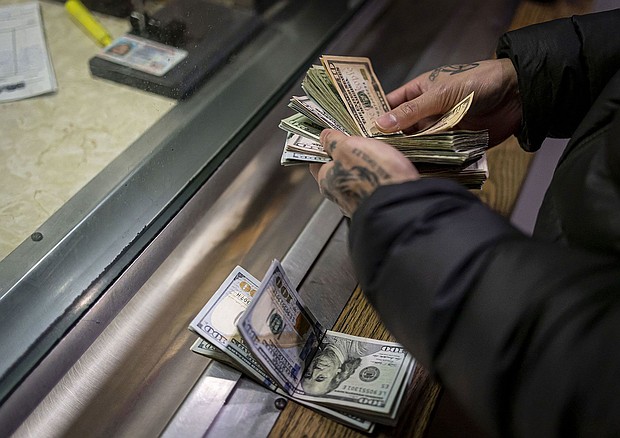 A man pays cash bail in the bond office to secure his brother's release in December 2022, at Division 5 of the Cook County Jail.
Mandatory Credit:	Brian Cassella/Chicago Tribune/Tribune News Service/Getty Images via CNN Newsource