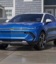 Front 7/8 view of 2025 Chevrolet Equinox EV 3LT in Riptide Blue parked in front of a home. Preproduction model shown. Actual production model may vary. Visit chevy.com/EquinoxEV for availability.