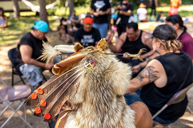 Joseph Warren (C), an Anishinaabe tribal community member, wears a traditional headdress during a Totem Pole consecration ceremony held by the House of Tear Carvers at the Shell City campground in Menahga, Minnesota on July 25, 2021.
Mandatory Credit:	Kerem Yucel/AFP/Getty Images via CNN Newsource