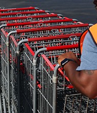 An employee pushes shopping carts outside a Costco Wholesale warehouse store in Hawthorne, California, on August 27.
Mandatory Credit:	Patrick T. Fallon/AFP/Getty Images via CNN Newsource