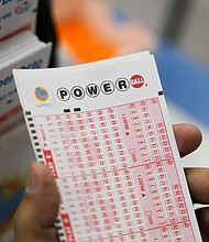 A customer holds a number slip for Powerball lottery tickets inside the Bluebird Liquor Store in Hawthorne, California, on August 25.
Mandatory Credit:	Patrick T. Fallon/AFP/Getty Images via CNN Newsource