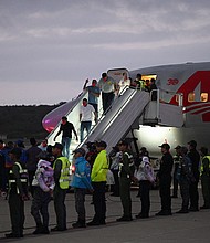 Venezuelan migrants who were jailed in El Salvador get off a plane at Simon Bolivar International Airport in Maiquetia, Venezuela on July 18.
Mandatory Credit:	Federico Parra/AFP/Getty Images via CNN Newsource