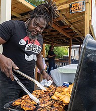 Richard McIntosh of L.I.B. True Taste cooks Liberian grilled chicken and jollof rice.