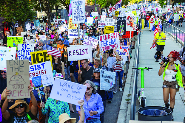Demonstrators head west on Broad Street during the “Workers Over Billionaires” Labor Day March in Richmond on Monday, Sept. 1. After remarks from local activists and community members at Monroe Park, the march, co-sponsored by RVA Indivisible and the 50501 Movement, proceeded to Lombardy Street, then Franklin Street, and returned to Monroe Park.