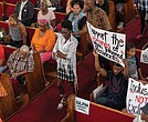 Gilpin Court resident Sylvia Davis waits in line to voice concerns about the Richmond Redevelopment and Housing Authority’s proposal to use its nonprofit arm, the Richmond Development Corporation, in the Gilpin Court community redevelopment during a discussion Thursday, Aug. 28, at Greater Mount Moriah Baptist Church.