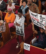 Gilpin Court resident Sylvia Davis waits in line to voice concerns about the Richmond Redevelopment and Housing Authority’s proposal to use its nonprofit arm, the Richmond Development Corporation, in the Gilpin Court community redevelopment during a discussion Thursday, Aug. 28, at Greater Mount Moriah Baptist Church.