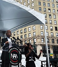 Protesters march on Wall Street in New York on Aug. 28 to denounce companies abandoning diversity, equity and inclusion initiatives. Left, The Rev. Al Sharpton addresses protesters during the March on Wall Street in New York urging action against economic inequality.