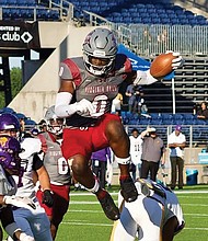 Virginia Union running back Curtis Allen (0) leaps over defenders during the Panthers’ 45-3 win over Miles College in the Black College Football Hall of Fame Classic on Sunday at Tom Benson Hall of Fame Stadium in Canton, OH.